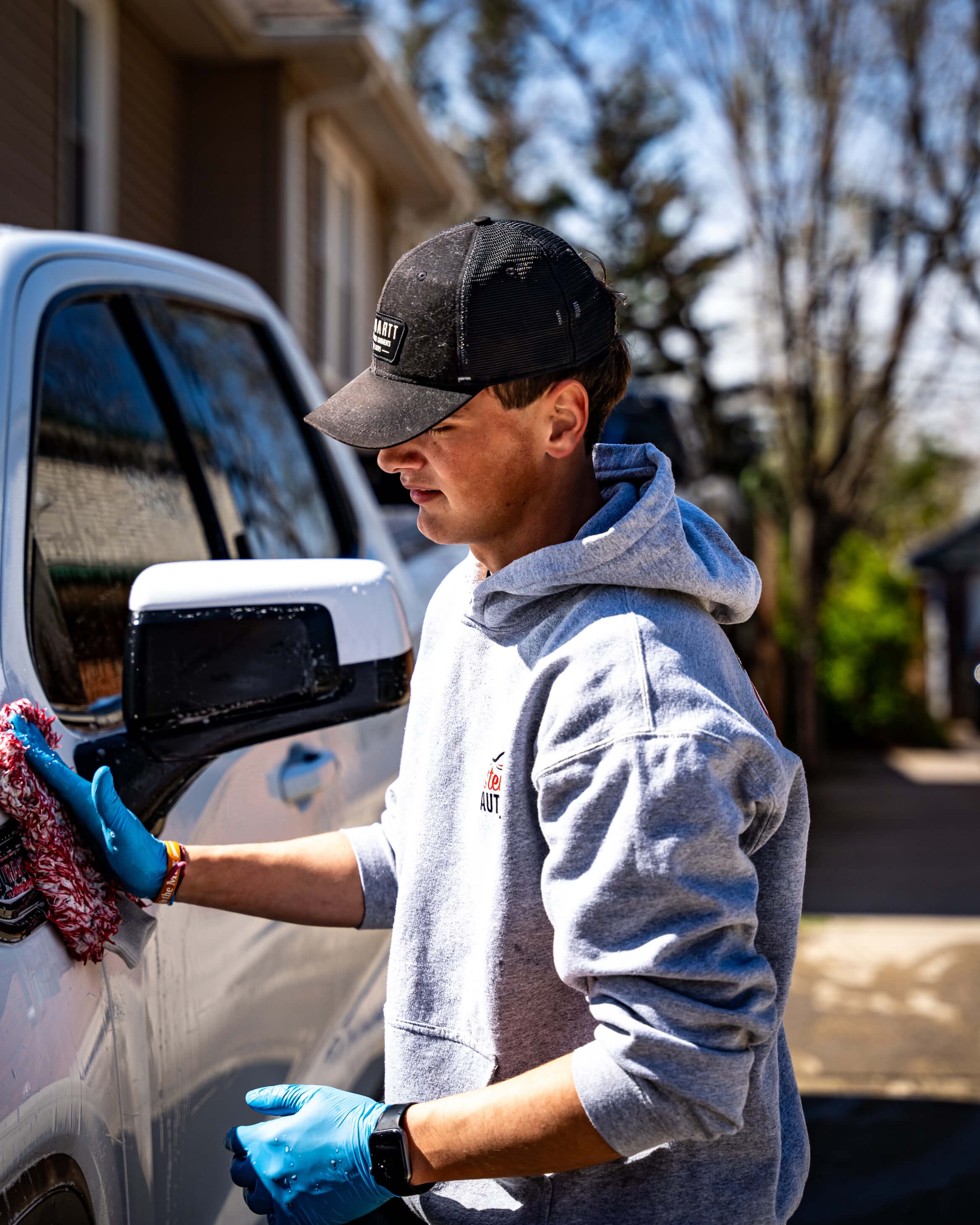 Hand washing a truck in the driveway